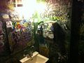 The famous graffiti-wallpapered bathroom in February 2012. Only a few months after the old graffiti had been - sadly - painted over in dark green, it once again flourished with humanity.